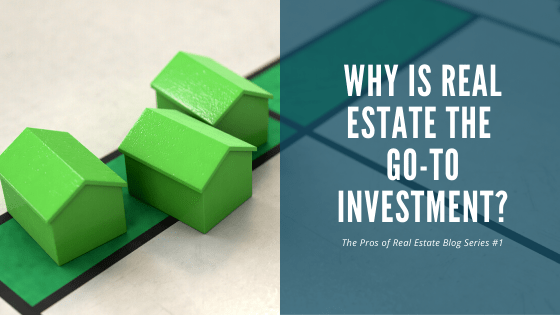 Green model houses on a board with the title 'Why Is Real Estate the Go-To Investment?' from a real estate blog series